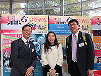 Photo taking with mainland partners in front of the booths